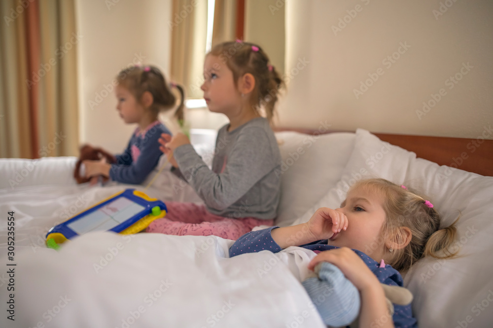 three little sisters lying in beds three little sisters lying in beds