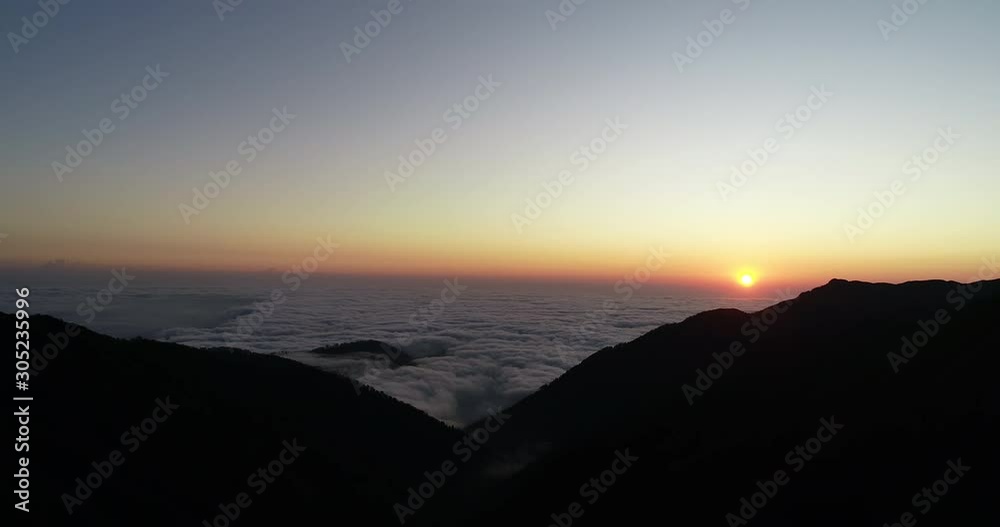 Sunset in the mountains of the Caucasus in the territory of Abkhazia. Kun-Iashta pass over the clouds.