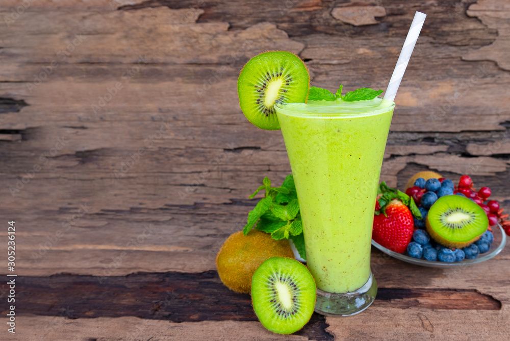 Kiwi yogurt fruit juice smoothie green colorful fruit juice milkshake blend beverage healthy high protein the taste yummy In glass drink episode morning on wood background.