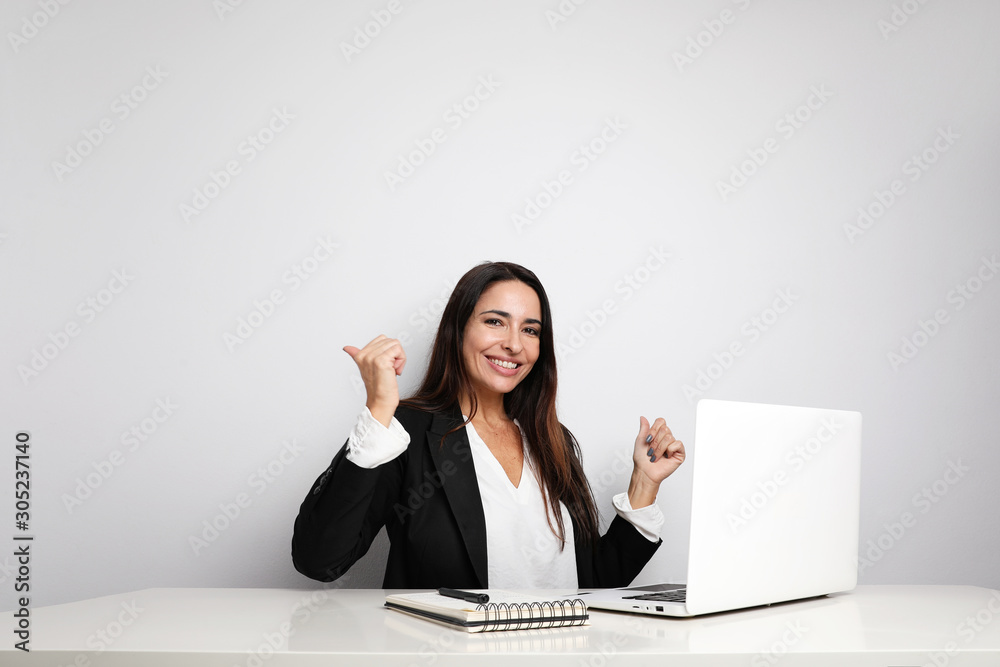 Office secretary young lady posing on the white wall and showing her notebook. Co-working. Office secretary young lady posing on the white wall and showing her notebook. Co-working.