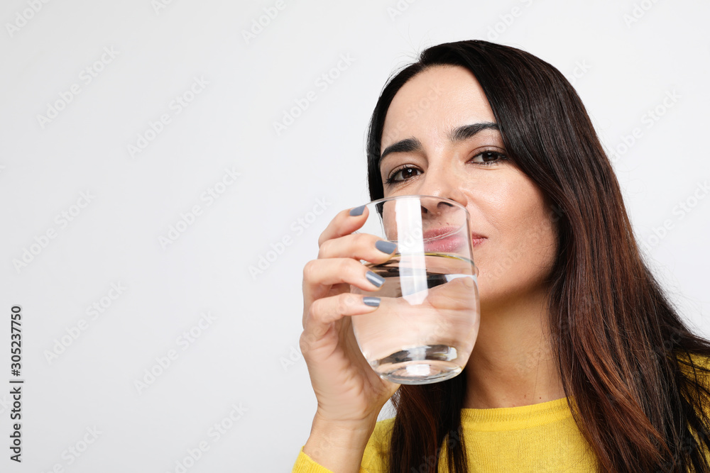 Close-up portrait of pretty woman drinking water. Healthy concept. Isolated. Close-up portrait of pretty woman drinking water. Healthy concept. Isolated.