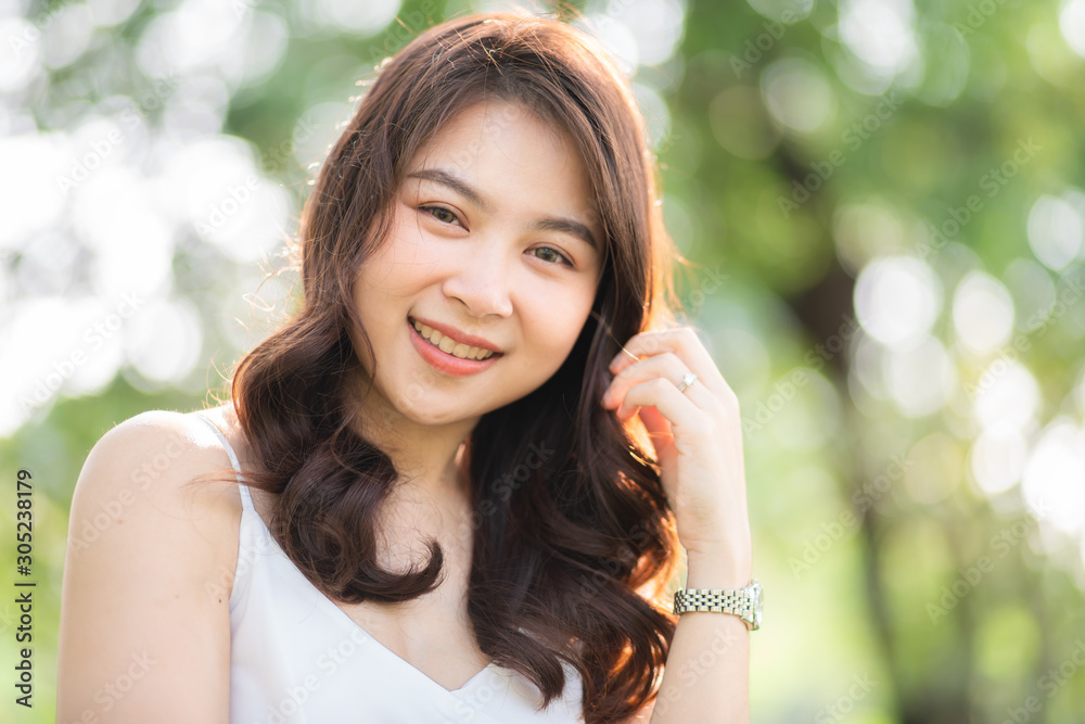 Portrait of smiling beautiful asian women in park morning light with bokeh Portrait of smiling beautiful asian women in park morning light with bokeh