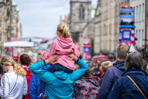 Little girl On Her Dads Shoulders.Edinburgh Festival Fringe.