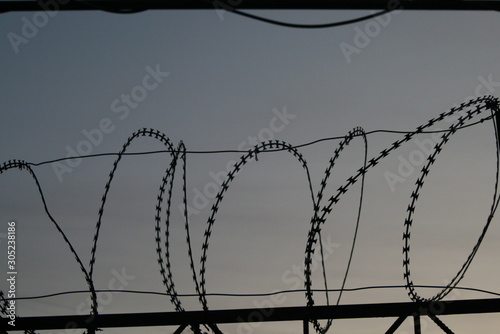 barbed wire on the fence at the closed territory, Russia