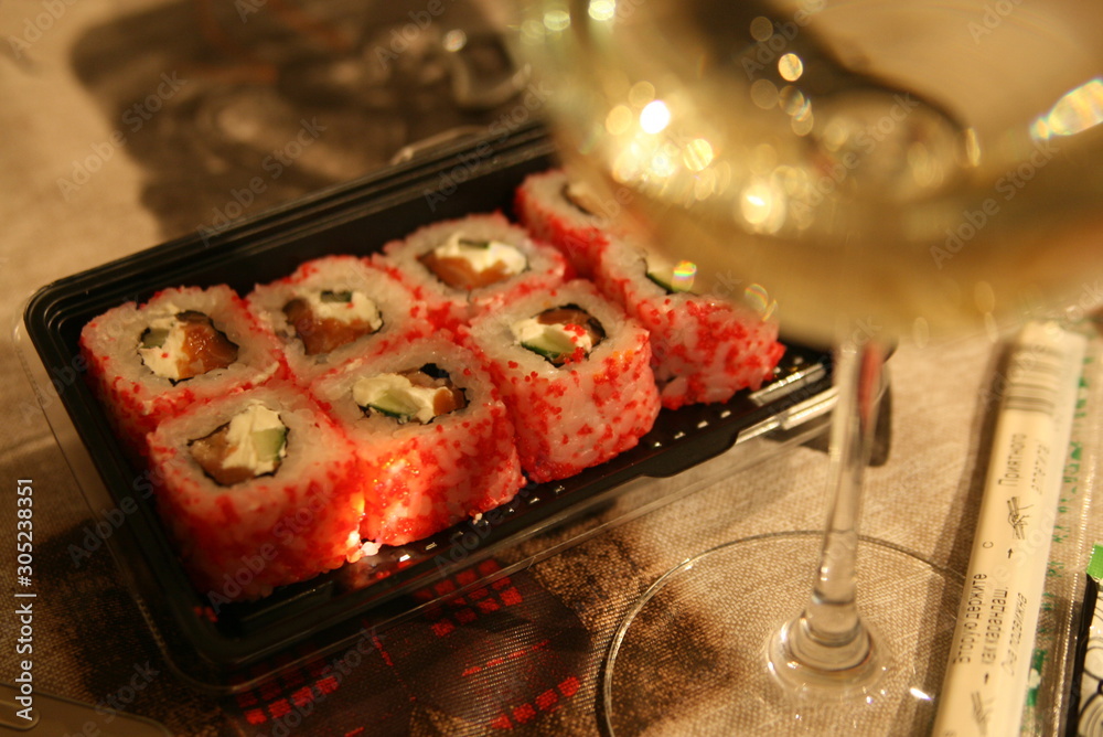 glass of white wine and Japanese rolls