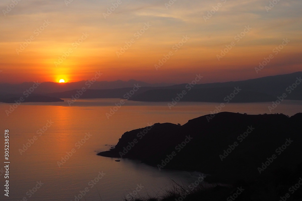 Beautiful and warm sky of sunset time with tropical sea and mountain view. Holidays, travel and nature, new day, inspiration concept