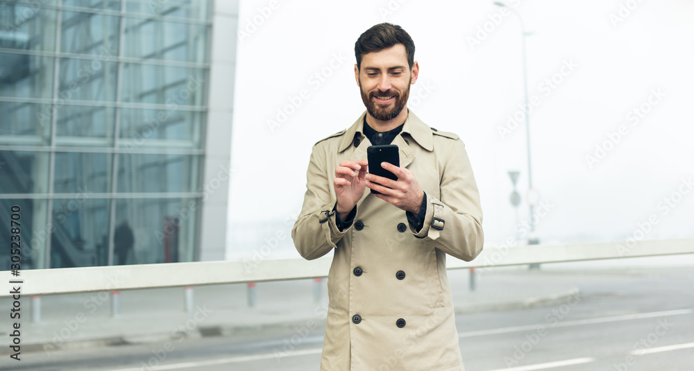 Businessman texting messages while walking. Businessman texting messages while walking.