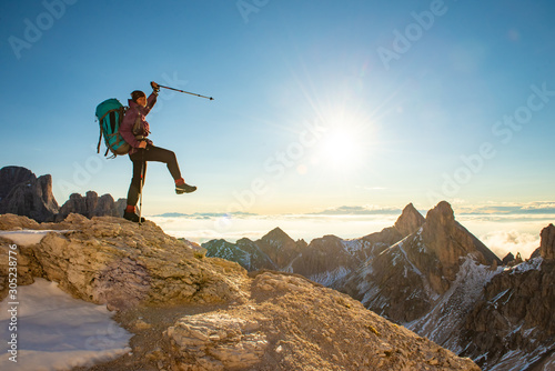 Sporty woman hiking in hight mountains, Dolomites Italy. Win, achievement, success, lifestyle concept.