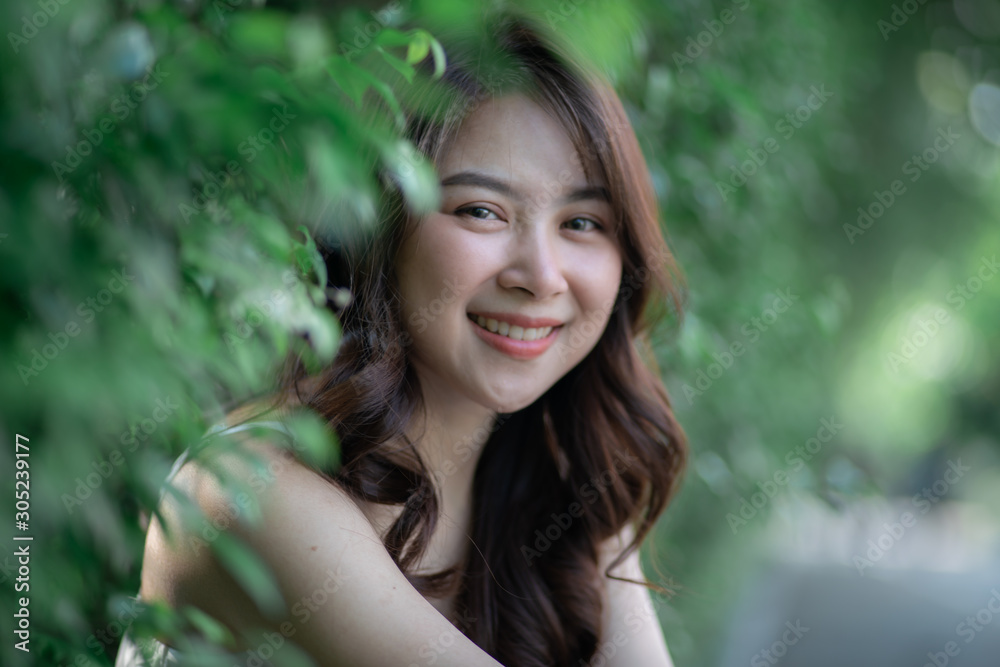 Portrait of smiling beautiful asian women in park morning light with bokeh Portrait of smiling beautiful asian women in park morning light with bokeh