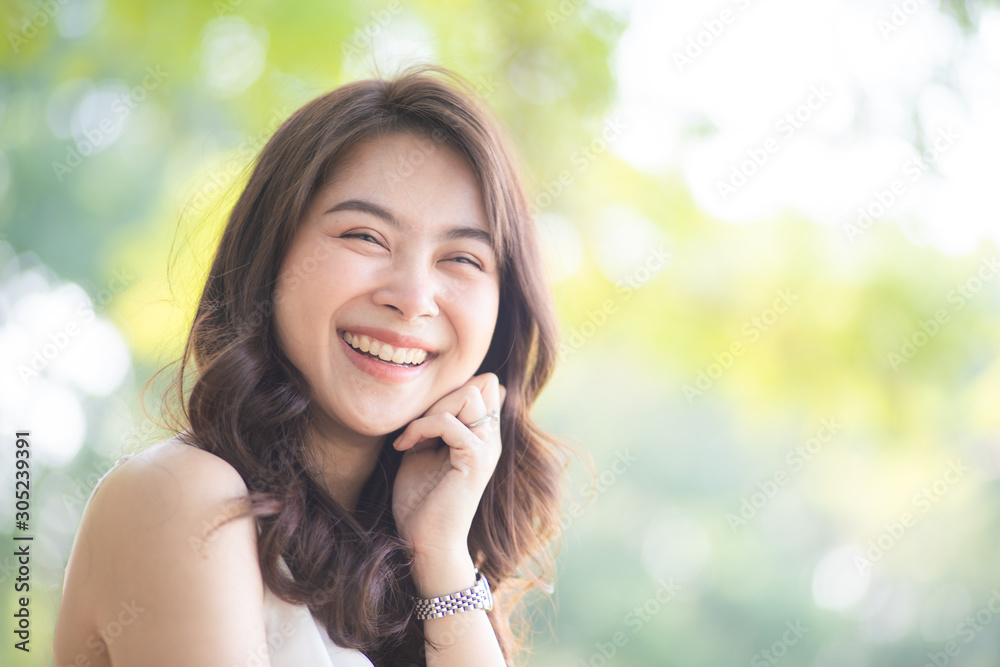 Portrait of smiling beautiful asian women in park morning light with bokeh Portrait of smiling beautiful asian women in park morning light with bokeh