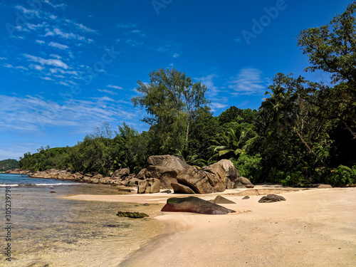 Tropical sand beach and boulders in Seychelles.