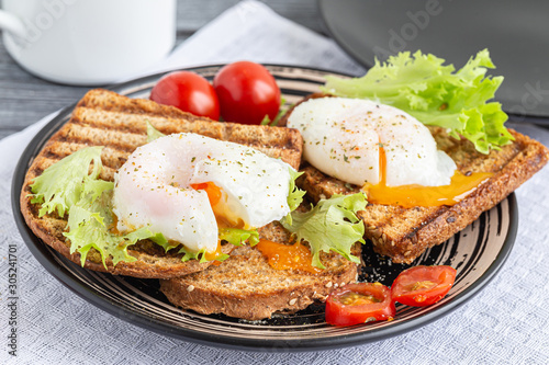 Sandwiches with poached egg on rye bread.