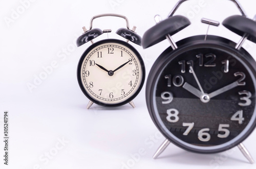 Alarm clock on white background. Selective focus.