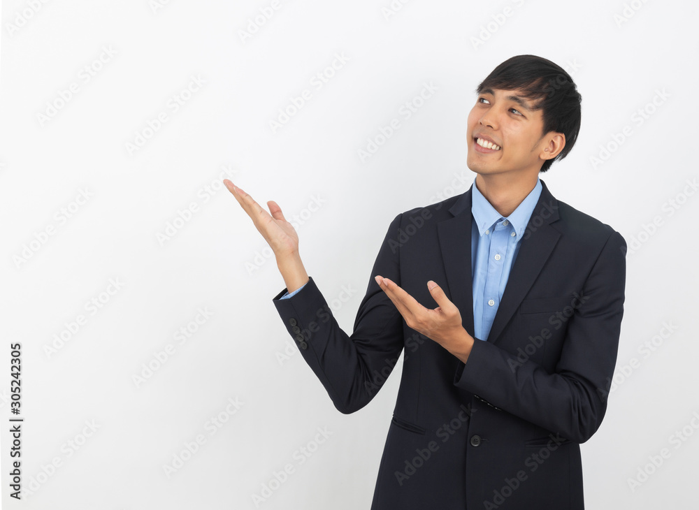 Young asian business man with blue shirt pointing to the side with a hand to present a product or an idea isolated on white background. Young asian business man with blue shirt pointing to the side with a hand to present a product or an idea isolated on white background.