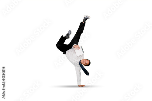 Businessman doing handstand over white background