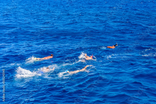 Group of tourists snorkeling in a Red sea. Summer vacation concept