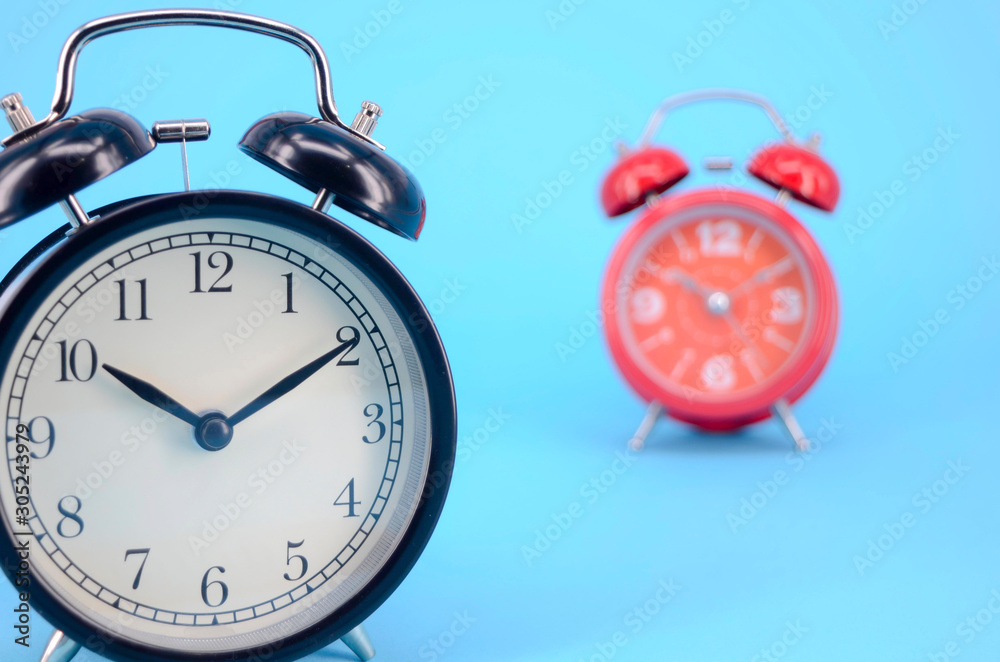 Alarm clock on blue background. Selective focus. Alarm clock on blue background. Selective focus.