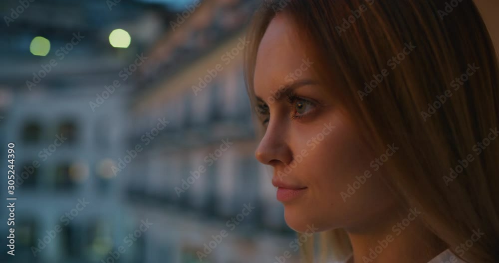 Close up of an young woman is enjoying a panoramic view on a sea with yachts at sunset from a terrace of a hotel room during her vacation. Close up of an young woman is enjoying a panoramic view on a sea with yachts at sunset from a terrace of a hotel room during her vacation.