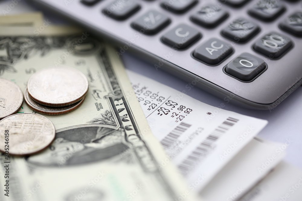 Paper bill lying at table with calculator and us dollar notes Paper bill lying at table with calculator and us dollar notes