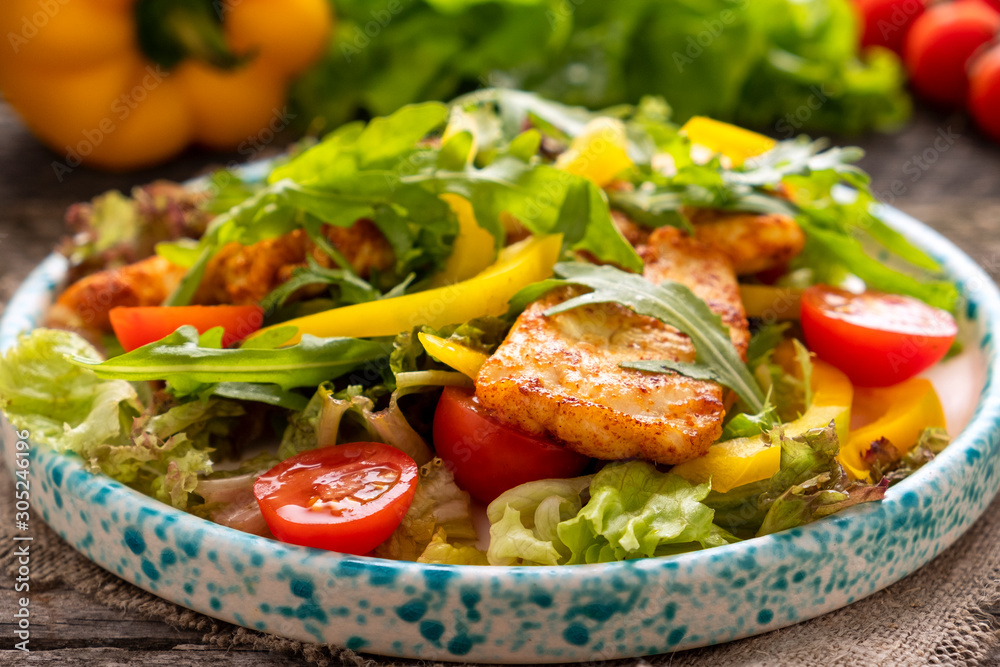 Fried chicken fillet with fresh vegetables on a plate. Healthy and diet food concept. Closeup Fried chicken fillet with fresh vegetables on a plate. Healthy and diet food concept. Closeup