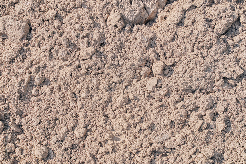 coarse sand with lumps. background. warm toning