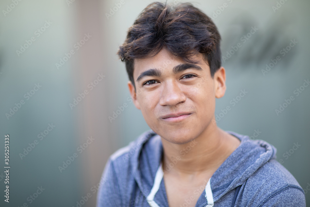 Obraz premium Portrait of a handsome Asian young man next to the blurred background