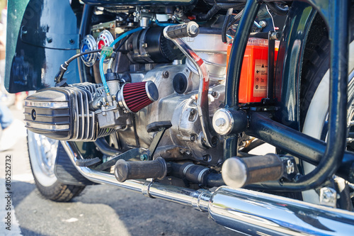 Close-up of a retro motorcycle engine at an auto show.