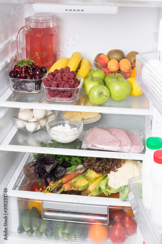open fridge with vegetables and fruits, front view