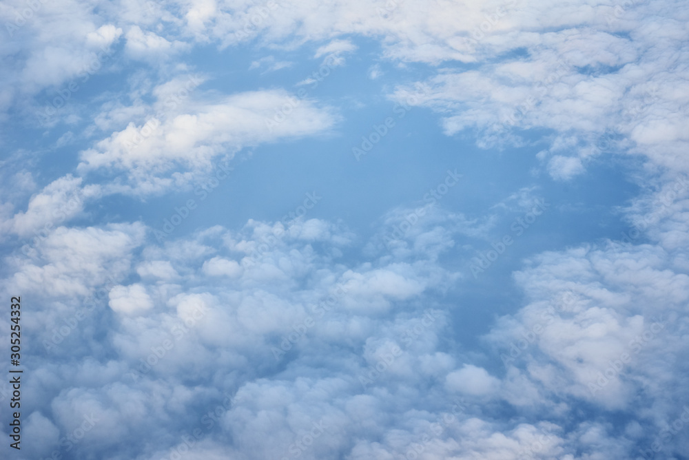 Aerial view of fluffy clouds. Top view of a beautiful cloudscape and blue sky