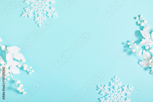 Christmas holiday composition. White decorations on pastel blue background. Christmas, New Year, winter concept. Flat lay, top view, copy space