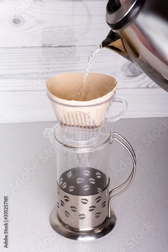 pour boiling water ground coffee placed in a funnel v60, for alternative brewing