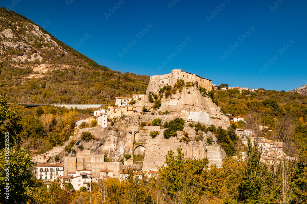 A view of the ancient village of Cerro al Volturno, surrounded by green woods and mountains. The Pandone castle stands on top of the hill, on a rock spur. Isernia, Molise, Italy.