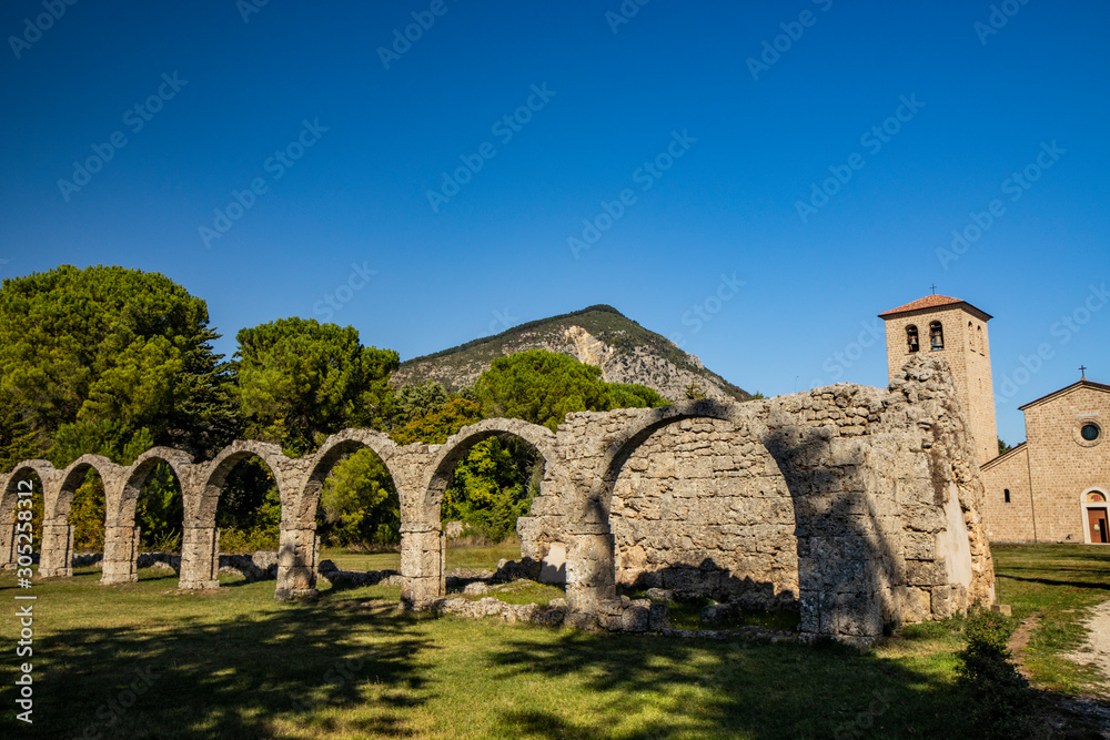 Fototapeta premium San Vincenzo al Volturno, a Benedictine monastery in Castel San Vincenzo and Rocchetta a Volturno. The new abbey. The remains of walls of an ancient building, with a series of stone arches.