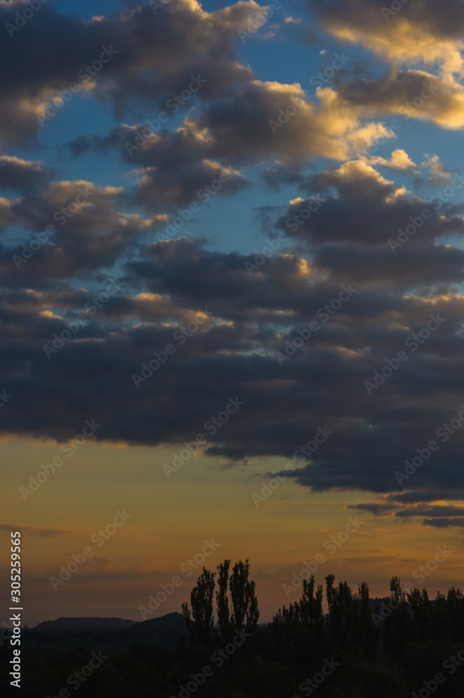 Landscape with dramatic light - beautiful golden sunset with saturated sky and clouds. Landscape with dramatic light - beautiful golden sunset with saturated sky and clouds.