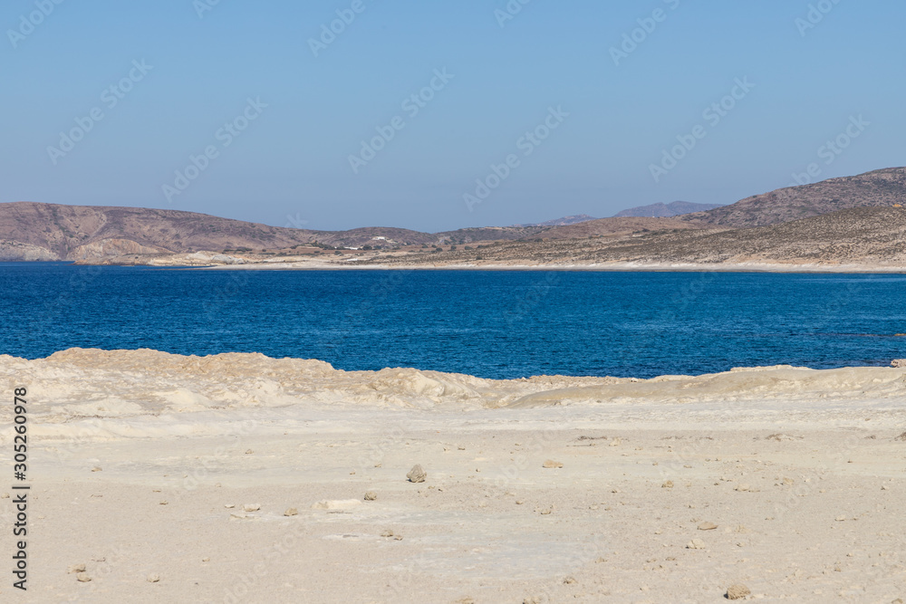 Shoreline of Mytakas beach with mountains Shoreline of Mytakas beach with mountains