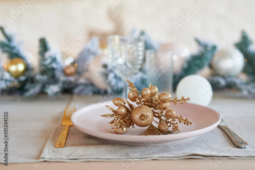 Christmas decor in kitchen. Christmas tableware. Christmas cooking utensils. Bright interior of New Year's cuisine. New Year card template. White Colors Kitchen. Christmas tree in the kitchen.