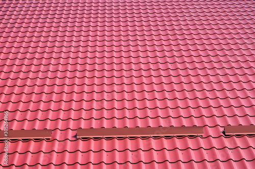 Red metal cover on the roof of the building, background