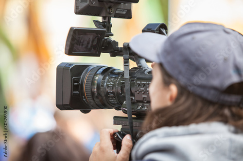 Man journalist with a modern large black video camera