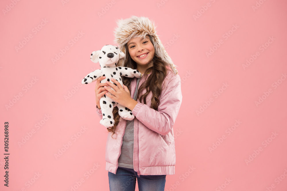 Lovely kid friendly with dog. Shelter for animals. Dalmatian dog. Games kids play. Happy small smiling child play with soft dog on pink background. Little child hold play toy. Kindness concept Lovely kid friendly with dog. Shelter for animals. Dalmatian dog. Games kids play. Happy small smiling child play with soft dog on pink background. Little child hold play toy. Kindness concept