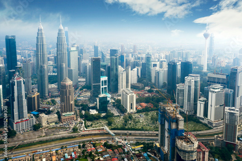 Petronas twin towers and KL tower over blue sky