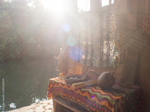 Authentic composition. An old table and old objects on it in the rays of the setting sun. Thailand © alexkazachok