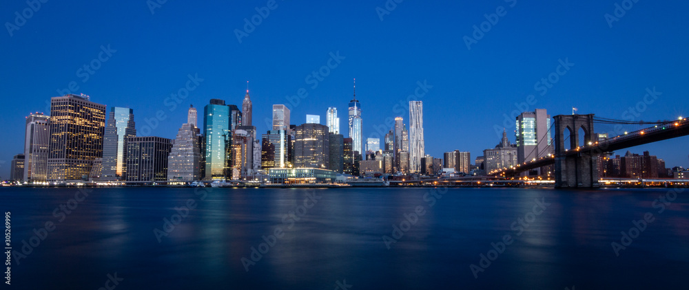 new york city skyline at dawn with a dark blue sky