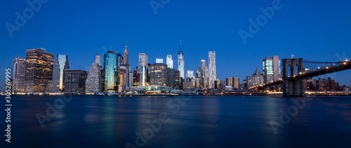 new york city skyline at dawn with a dark blue sky © Julian