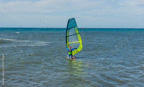 Funny windsurfing on the crystal clear water