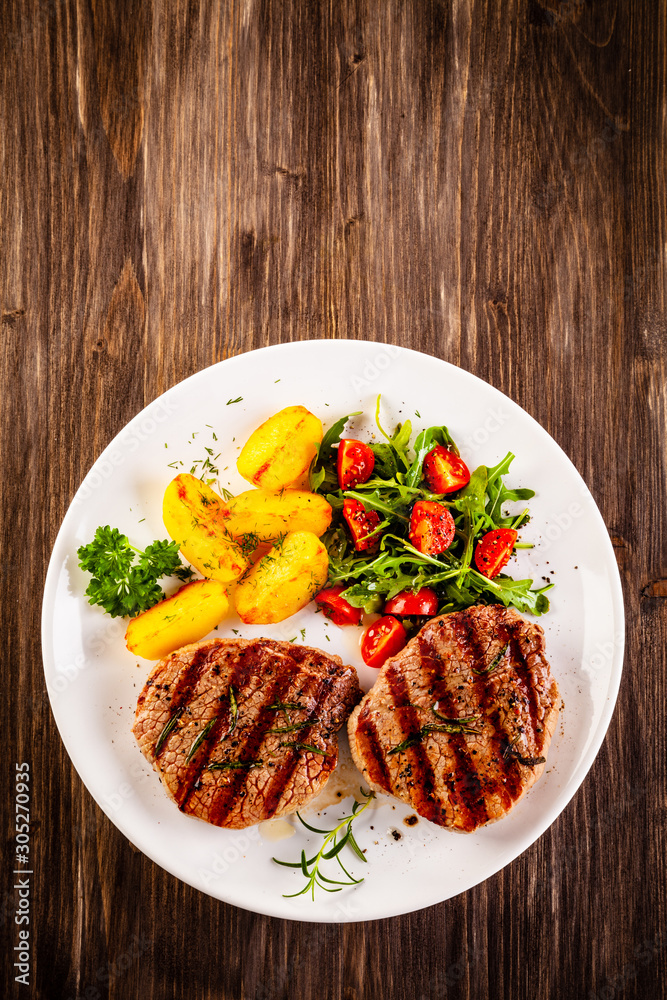 Grilled steak with baked potatoes and vegetables Grilled steak with baked potatoes and vegetables