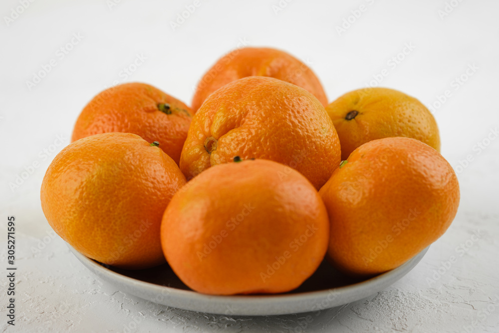 sweet and ripe whole and peeled tangerines (mandarins) on white background isolated sweet and ripe whole and peeled tangerines (mandarins) on white background isolated