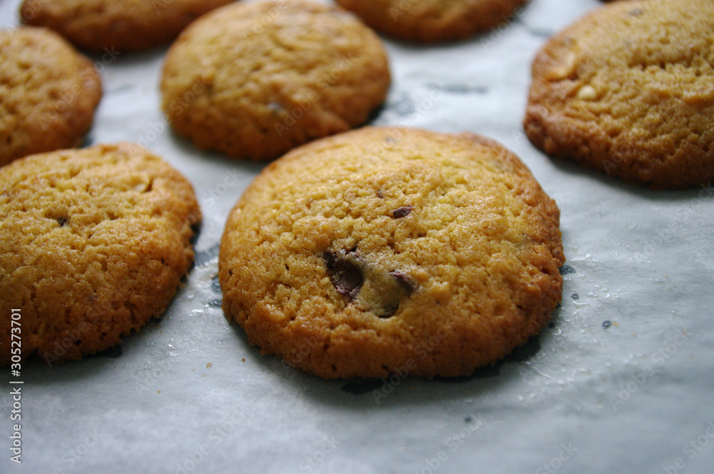 Fresh baked cookies with chocolate, close up. on baking paper. Fresh baked cookies with chocolate, close up. on baking paper.