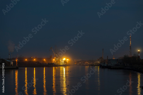 in the evening, ship lights shine in the port