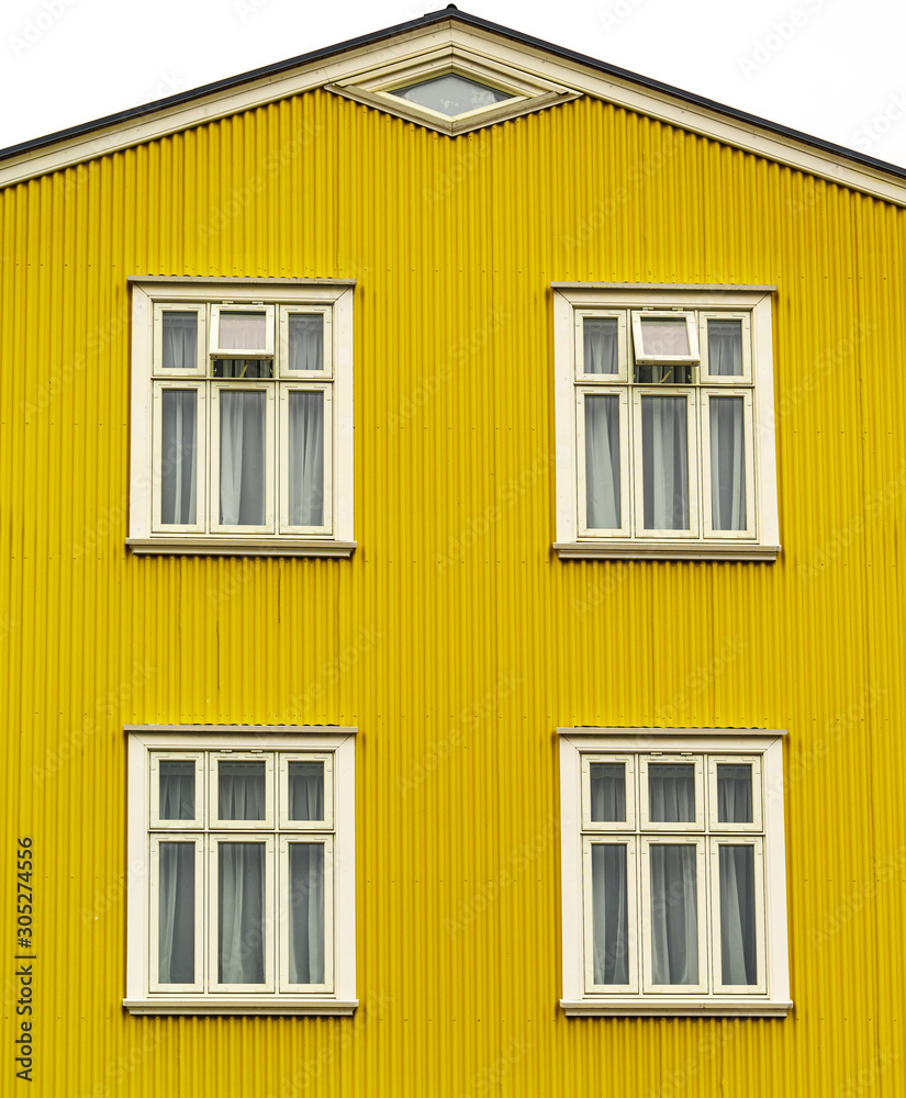 Yellow facade of a house in Iceland. Street shot in Reykjavik. 