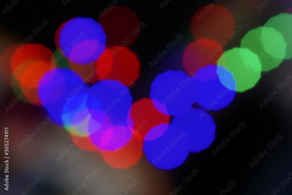 Abstract colorful bokeh blurred lights on a dark background